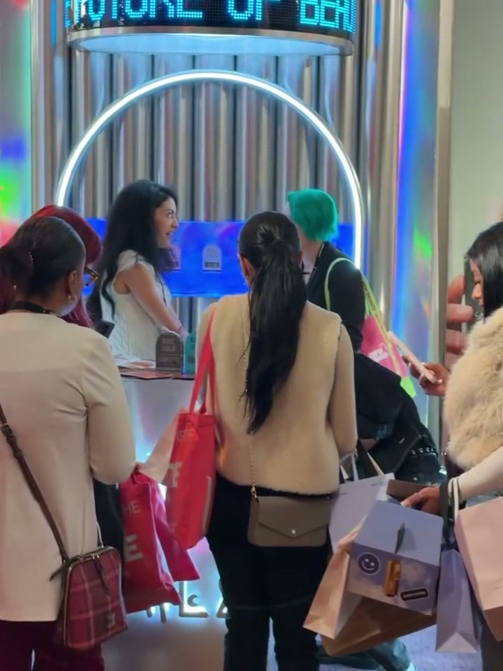 Visitors gathered in front of the Rave Nailz booth